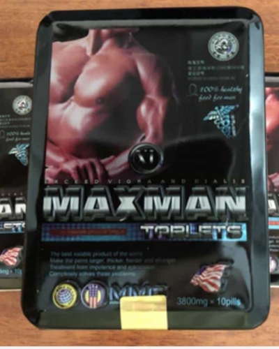 Viên uống Maxman USA hỗ trợ cường dương – Ba hộp thiếc đen Maxman trên bàn gỗ